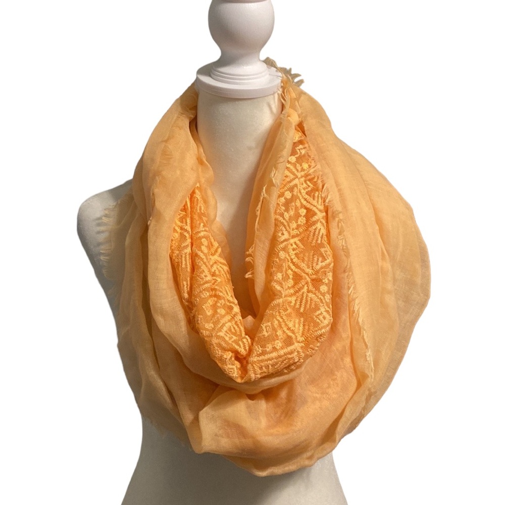 Sheer lightweight sherbet orange lace accent scarf. Raw fridge hemline